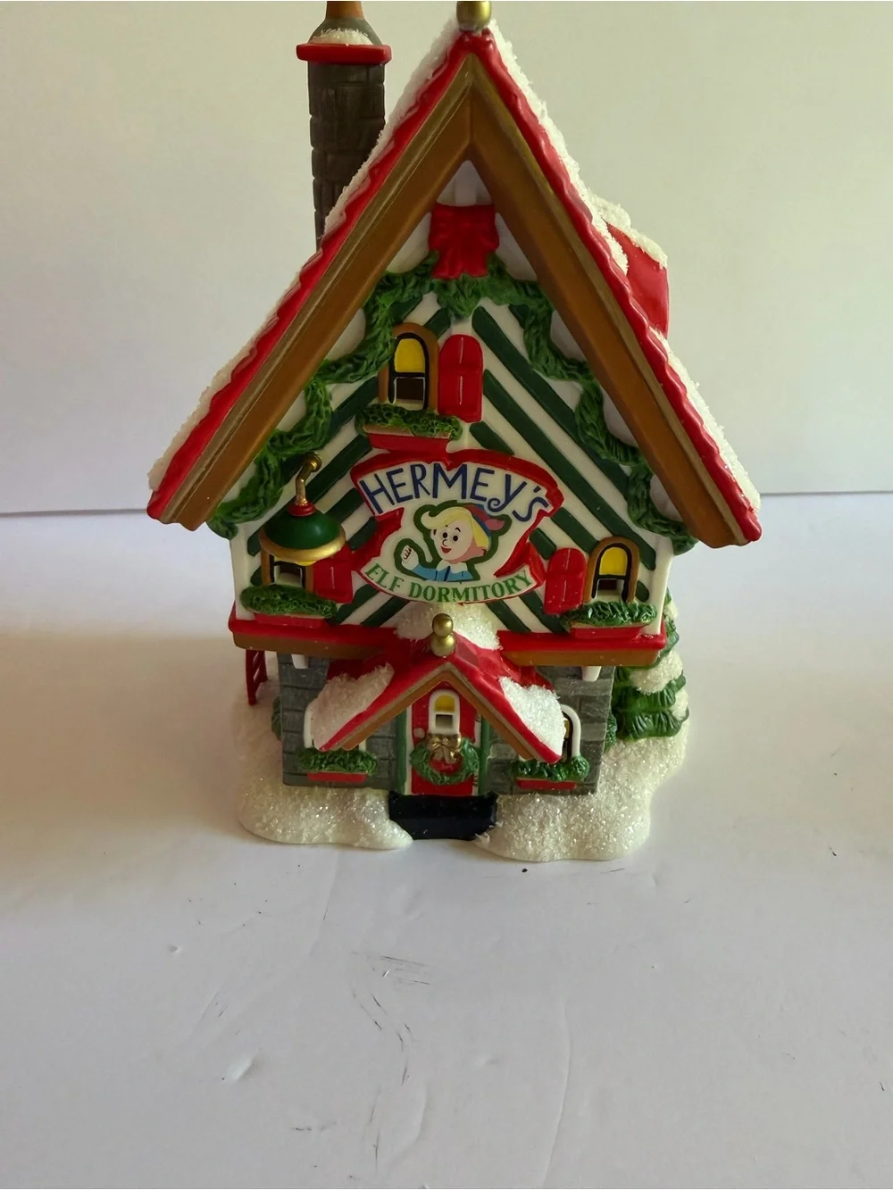Department 56 Rudolph Hermey's Elf Dormitory - Red, Green, White, Gold